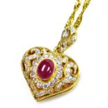 A heart shaped pierced diamond cabachon ruby set pendant on chain, a centrally set ruby of 8.4mm x 5