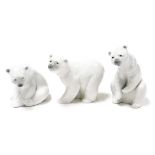 Three Lladro porcelain figures modelled as polar bears, in standing and seated pose.