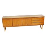 A vintage 1970's teak sideboard, with a central drop down drinks cabinet flanked by a pair of cupboa
