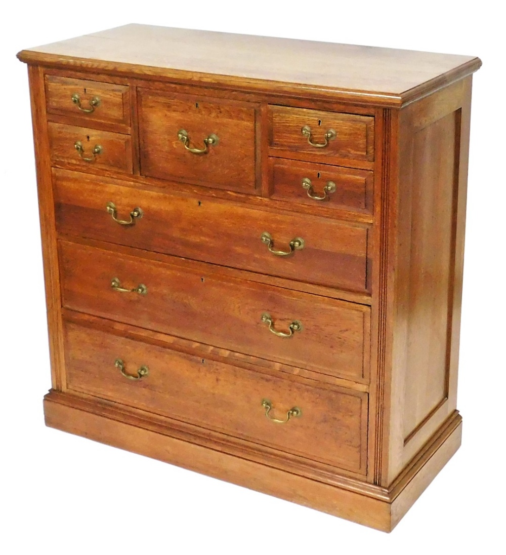 A Victorian oak chest of one deep and four short drawers, over three long graduated drawers, raised