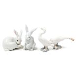 Two Lladro porcelain figures of rabbits, and two figures of geese. (4)