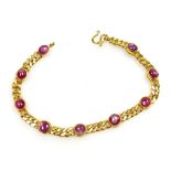 A cabachon ruby set bracelet, nine round rubies of 4mm diameter average, in rub over setting to curb