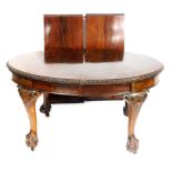 A Victorian mahogany oval wind out dining table, with two additional leaves, the top with a gadroone