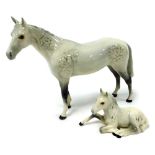 A Beswick Pottery figure of a dappled grey horse, together with a foal. (2)