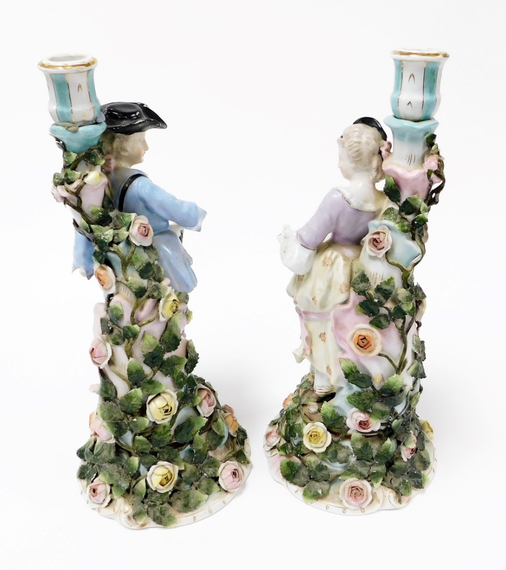 A pair of late 19thC Sitzendorf porcelain figural candlesticks, modelled as a gallant and lady, hold - Image 2 of 5