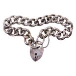 A heavy silver curb link bracelet, on a heart shaped padlock clasp, with safety chain as fitted, 57.