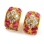 A pair of cabachon ruby and diamond set open work earrings, each set with eight rubies of 3.5mm x 2.