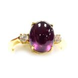 A cabachon ruby and diamond set dress ring, the central stone of 8.3mm x 7.5mm, high standing with a