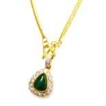 A tear drop jade and diamond set pendant on chain, the central cabachon stone of 8.8mm x 6.8mm wides