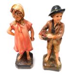 A pair of 1930's chalkware figures, a young girl and boy, each 47cm high.