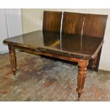 A Victorian style mahogany draw leaf dining table, with three additional leaves, raised on turned an