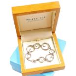 A White Ice silver and diamond set swirl link bracelet, boxed.