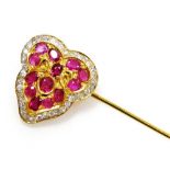 A ruby and diamond set stick pin, the heart shaped head set with thirteen various size small rubies,