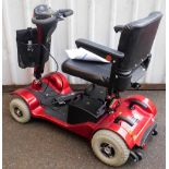 A Sterling Sapphire 2 mobility scooter, in red trim, with charger and cables.