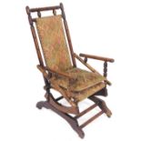 A 19thC American oak rocking chair, with tapestry seat, back and cushion, raised on castors.