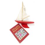 A Star Yacht pond yacht, 30cm wide, together with a stamp album containing Great Britain and world s