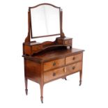 An Edwardian mahogany dressing chest, the swing frame mirror inset with bevelled glass, on a super s