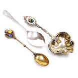 Three silver spoons, comprising a George V silver preserve spoon, with shaped bowl and line and cros