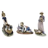 A Lladro Porcelain figure of a Jewish boy with a puppy, looking at a menorah on a table, together wi