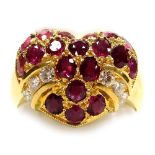 A heart shaped ruby and diamond set ring, the head set with nineteen oval faceted stones with six ti