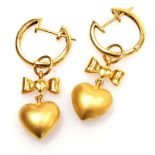 A pair of hoop and drop earrings, a pierced heart below a bow to a clip and post hoop, 3.6cm x 1.1cm