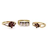 A 9ct gold and garnet set flower head ring, size P, another similar, size L, and a CZ set three ston