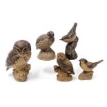 Five Poole buff pottery figures of birds, including a quail, owls, and a wren.