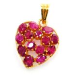 A heart shaped ruby set pendant, fourteen rubies close claw set in precious yellow metal, average st