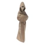 A Lladro matt brown porcelain figure of a monk, modelled in standing pose, printed mark, 33.5cm high