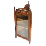 A Victorian mahogany corner display cabinet, the galleried top over a glazed door enclosing two shel