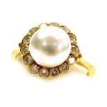 A pearl and diamond set cluster ring, the central pearl drilled and set surrounded by tiny diamonds