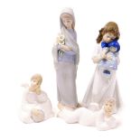 A Lladro matt figure of a girl holding a bunch of Calla lilies, a Nao figure of a girl holding a dol