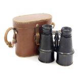 A pair of World War I binoculars, stamped British made, 12cm high, in leather casing.