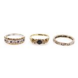 A 9ct gold sapphire and diamond three stone ring, size N, a clear gem set full eternity ring, in whi
