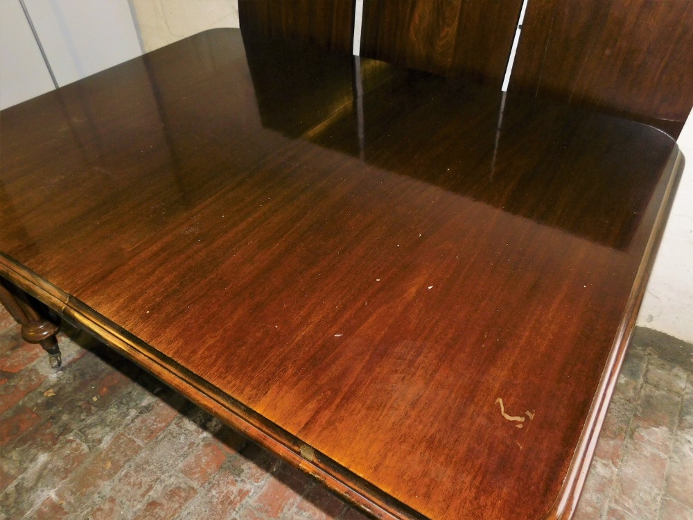 A Victorian style mahogany draw leaf dining table, with three additional leaves, raised on turned an - Image 3 of 3