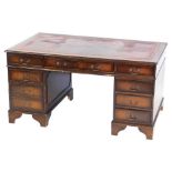 A mahogany twin pedestal desk, with a gilt tooled red leather top, above one long and two short draw