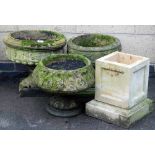 Three composition garden planters, each of circular form, of differing designs, the largest 40cm hig