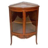 An Edwardian mahogany bow front corner cabinet, with satinwood cross banding and ebony line inlay, w