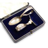A George V silver spoon and pusher set, both bearing engraved initials and dated 18.4.37, London 193