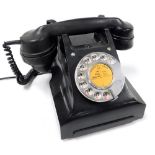 A vintage black Bakelite dial telephone, DC2099.