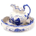 A Staffordshire Ironstone wash jug and bowl, of rococo form, printed in blue and white with cabbage