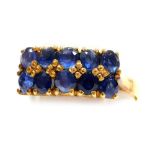 A double row sapphire set dress ring, two rows of five mine cut sapphires, set in precious yellow me
