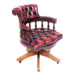 A mahogany and red leather captain's chair, with button back and seat, on castors, 62cm wide. The up