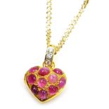 A heart shaped cabachon ruby set pendant locket, set with ten cabachon rubies of 3.8mm average, to a