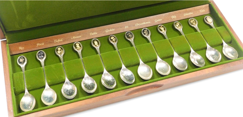 A set of twelve Royal Horticultural Society silver flower spoons, Sheffield 1973-5, 9.85oz, in fitte