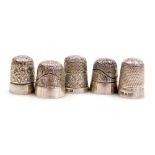 Five silver thimbles, with engraved or punched decoration, 0.84oz.