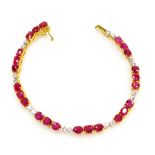 A ruby and diamond set tennis style bracelet, twenty four rubies of 4mm x 3.5mm average, in groups o