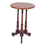 A Victorian style mahogany side table, raised on a triple turned column support, united by a trefoil