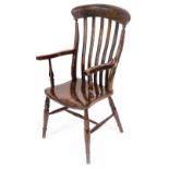 A Victorian oak and elm lath back kitchen chair with solid saddle seat raised on turned legs united