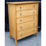 A pale oak chest of five long drawers, raised on stile supports, 126cm x 49.5cm.